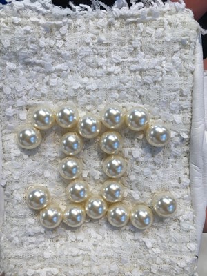 Lot 18 - A pair of Chanel haute couture by Karl Lagerfeld white tweed mitts, Spring-Summer 2014