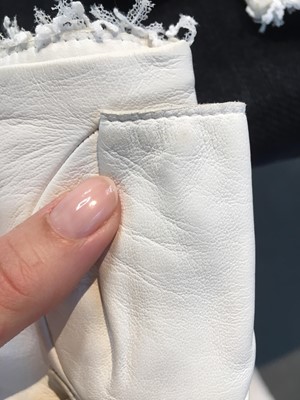 Lot 18 - A pair of Chanel haute couture by Karl Lagerfeld white tweed mitts, Spring-Summer 2014