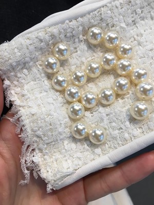 Lot 18 - A pair of Chanel haute couture by Karl Lagerfeld white tweed mitts, Spring-Summer 2014