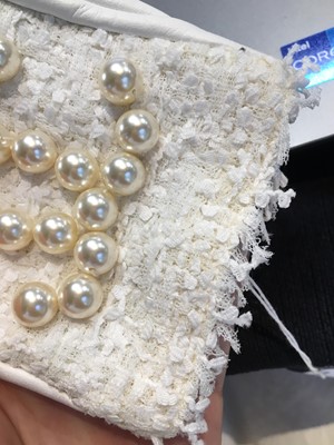 Lot 18 - A pair of Chanel haute couture by Karl Lagerfeld white tweed mitts, Spring-Summer 2014