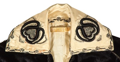 Lot 523 - A Liberty & Co embroidered black velvet cape, 1910-15