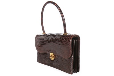 Lot 27 - An Hermès chocolate brown crocodile handbag,...