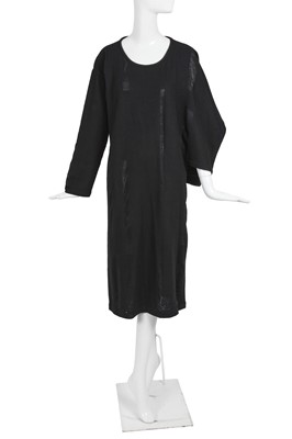 Lot 60 - An important Comme des Garçons distressed black wool dress, probably ‘Holes’ collection, Autumn-Winter 1982-83