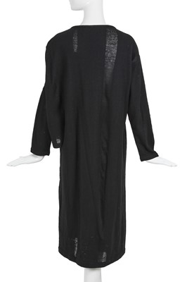 Lot 60 - An important Comme des Garçons distressed black wool dress, probably ‘Holes’ collection, Autumn-Winter 1982-83