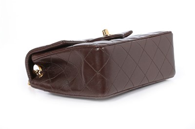Lot 24 - A Chanel quilted brown leather bag, 1990s,...