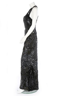 Lot 188 - An ornately sequinned black evening gown,...