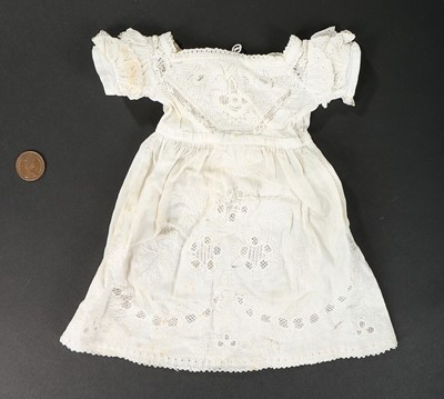 Lot 438 - A miniature Ayreshire-work sampler-dress,...