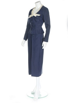 Lot 124 - A Jacques Fath couture navy wool day suit,...