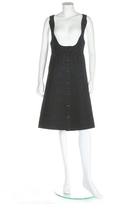 Lot 175 - A Courrèges black wool pinafore dress, circa...