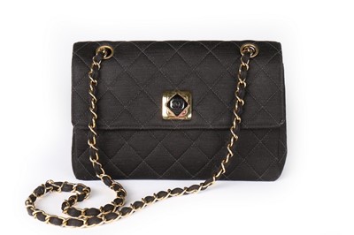 Lot 211 - A Chanel black quilted jersey handbag, 1980s,...