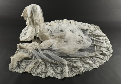 Lot 439 - A tulle bridal veil edged in 1860s Brussels...