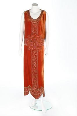 Lot 62 - An embroidered brick-red velvet evening dress,...