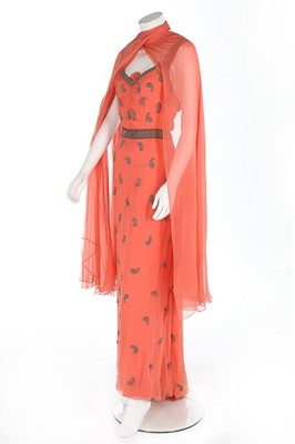 Lot 98 - A beaded salmon-pink chiffon evening gown,...