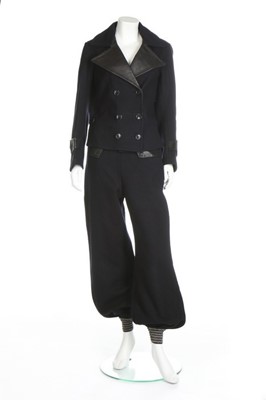 Lot 104 - A navy wool and black leather ski suit, 1936-9,...