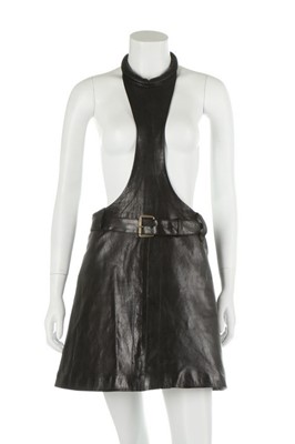Lot 117 - A Pierre Cardin black leather pinafore, 1967,...