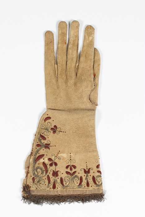 Lot 12 - A single buff leather glove, traditionally...