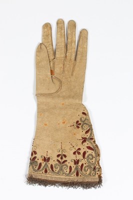 Lot 12 - A single buff leather glove, traditionally...