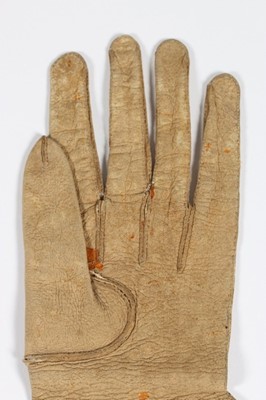 Lot 12 - A single buff leather glove, traditionally...