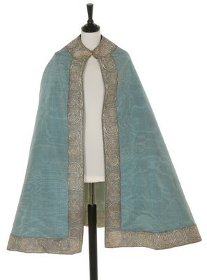 Lot 28 - A fine and rare blue watered silk cape,...