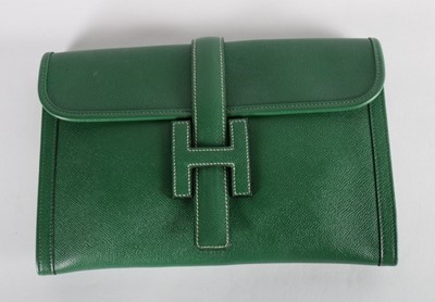 Lot 13 - An Hermès green leather pochette, stamped...