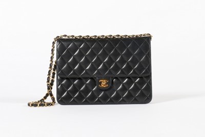 Lot 23 - A Chanel quilted navy leather bag, stamped to...