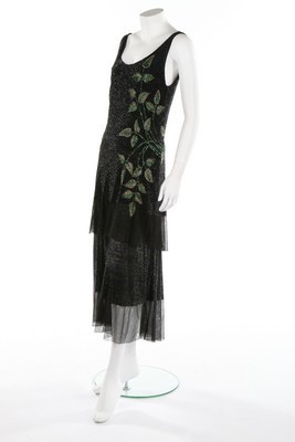 Lot 64 - A tiered bugle beaded evening gown, circa 1929,...