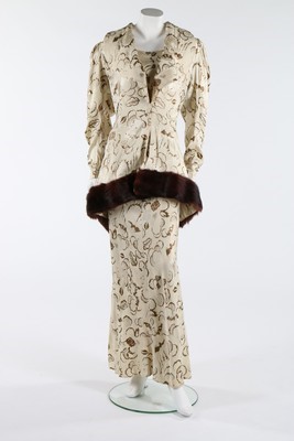 Lot 71 - A gold stencilled ivory damask satin evening...