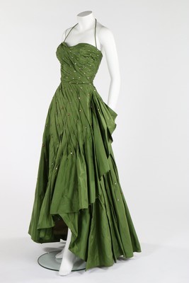 Lot 105 - A Norman Hartnell couture green taffeta ball...