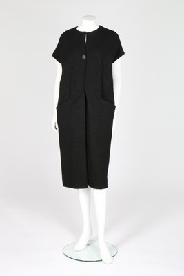 Lot 107 - A Balenciaga couture black boucl wool 'sack'...