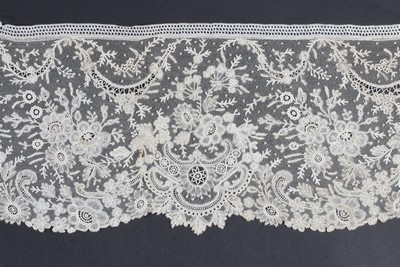 Lot 386 - A Brussels mixed lace flounce, circa 1880,...