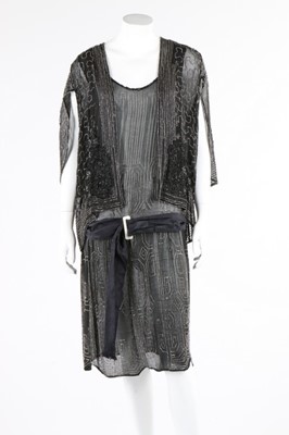 Lot 112 - A beaded black crepe flapper dress and similar...