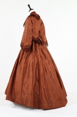 Lot 212 - A brown taffeta day dress circa 1870, the...