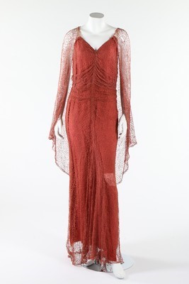 Lot 306 - A coral pink spider-web lace and chiffon...