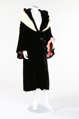 Lot 310 - A black velvet evening coat, early 1930s, with...