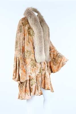 Lot 311 - A printed pale apricot cut-velvet evening coat,...