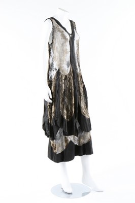Lot 30 - A gold lamé and black cobweb-lace cocktail...