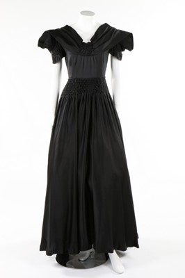 Lot 50 - A Norman Hartnell couture black satin dress,...