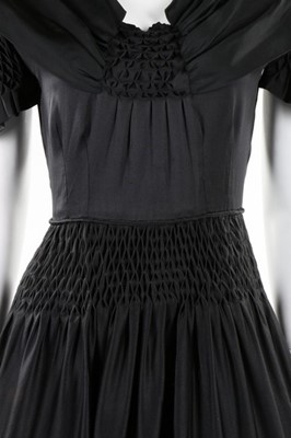 Lot 50 - A Norman Hartnell couture black satin dress,...