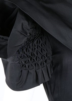 Lot 50 - A Norman Hartnell couture black satin dress,...