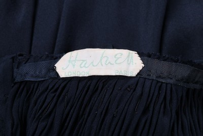 Lot 50 - A Norman Hartnell couture black satin dress,...