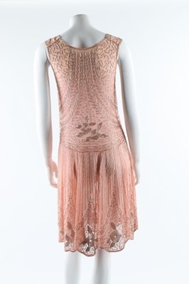 Lot 12 - A beaded pink muslin flapper dress, circa 1928,...