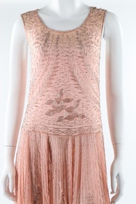 Lot 12 - A beaded pink muslin flapper dress, circa 1928,...