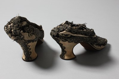 Lot 105 - A pair of lavishly embroidered black satin...
