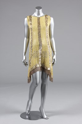 Lot 25 - A beaded primrose-yellow muslin flapper dress,...