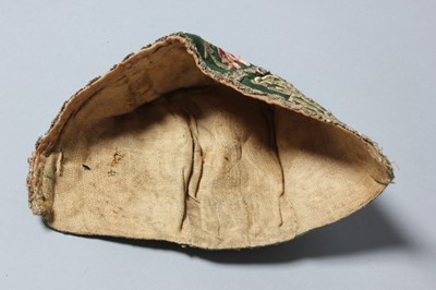 Lot 150 - An embroidered green satin baby cap, probably...