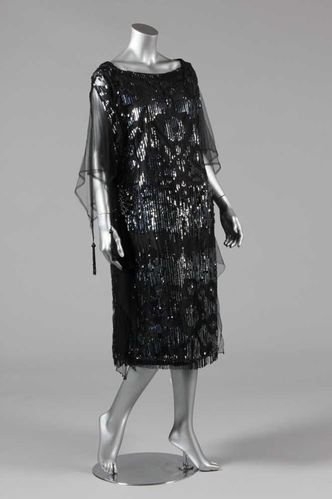 Lot 11 - A sequinned black tulle tabard dress, early...