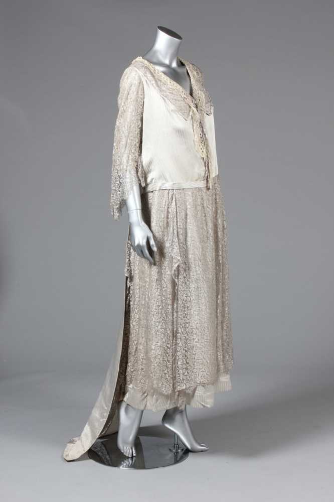 Lot 23 - A striped satin and silver lace evening gown,...