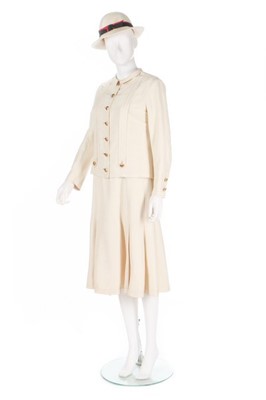Lot 27 - A Chanel couture ivory silk ensemble, 1974,...