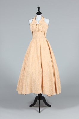 Lot 227 - A pale oyster-pink moire halter-neck evening...